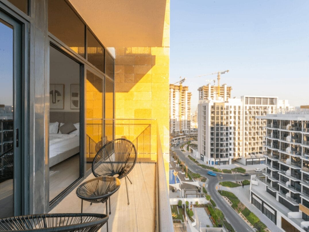 Modern balcony overlooking a cityscape with high-rise buildings under construction.